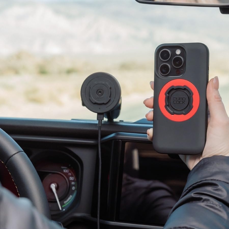 iPhone mounted in a vehicle showing wireless charging indicator on screen