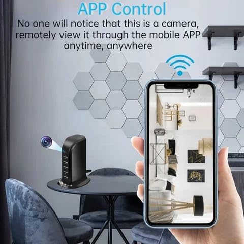A smartphone displaying the live feed from the Smars USB Power Adapter Camera, showing a room interior. The image emphasizes remote viewing via a mobile application.