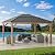Sunjoy Hardtop Gazebo 13 x 15 ft. Standard Cedar Framed Wood Gazebo, Outdoor Patio Gazebo with Dark Brown Steel and Polycarbonate Hip Roof and Ceiling Hook, Dark Brown Roof + Dark Wood Frame