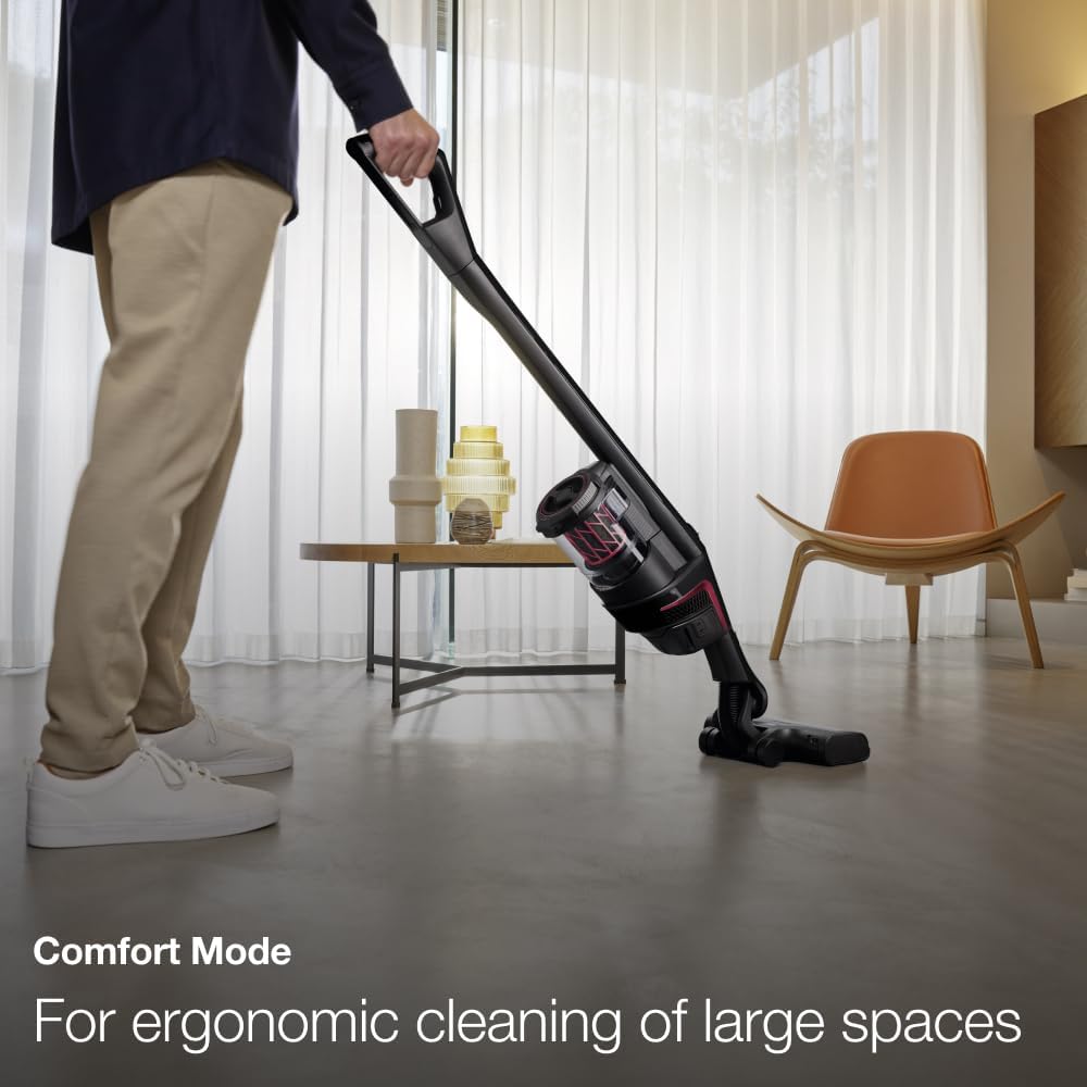 A person using the Miele Triflex HX1 in Comfort Mode, vacuuming a floor while standing upright.