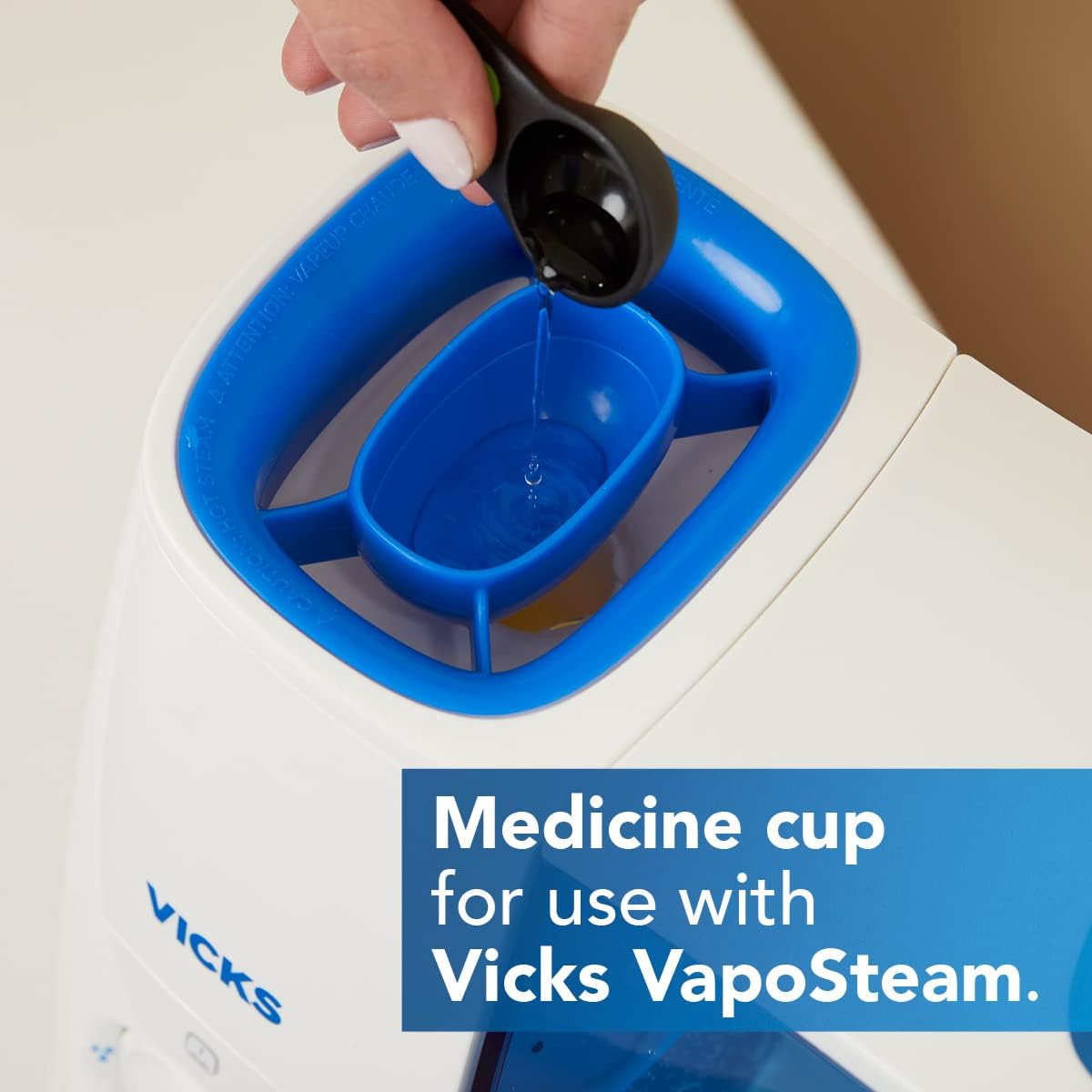 Adding Vicks VapoSteam to the medicine cup