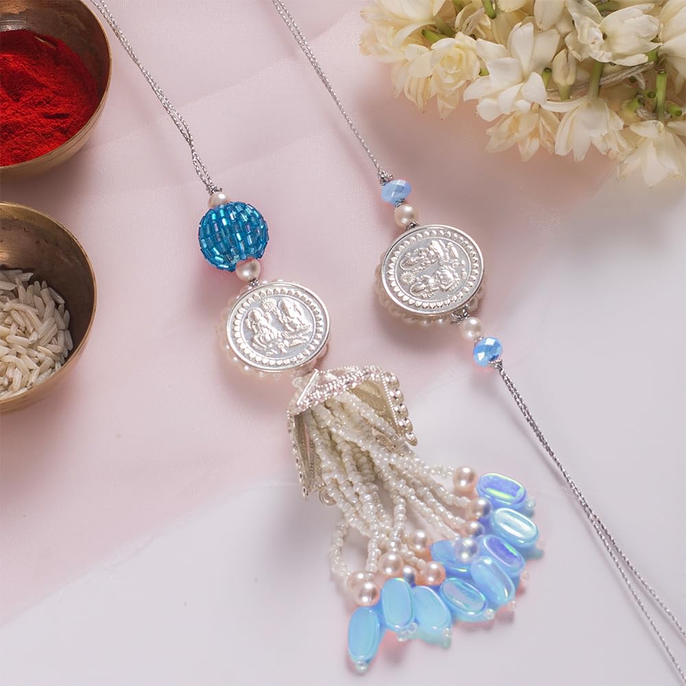 CONFETTI GIFTS Boys Rakhi Gift Combo For Brother Bhaiya And Bhabhi | Set Of 2 Rakhi With Roli-Rice And Greeting Card | Silver Coin Blue Couple Rakhi (B0D9HJ3PS3) Amazon Price History, Amazon Price Tracker
