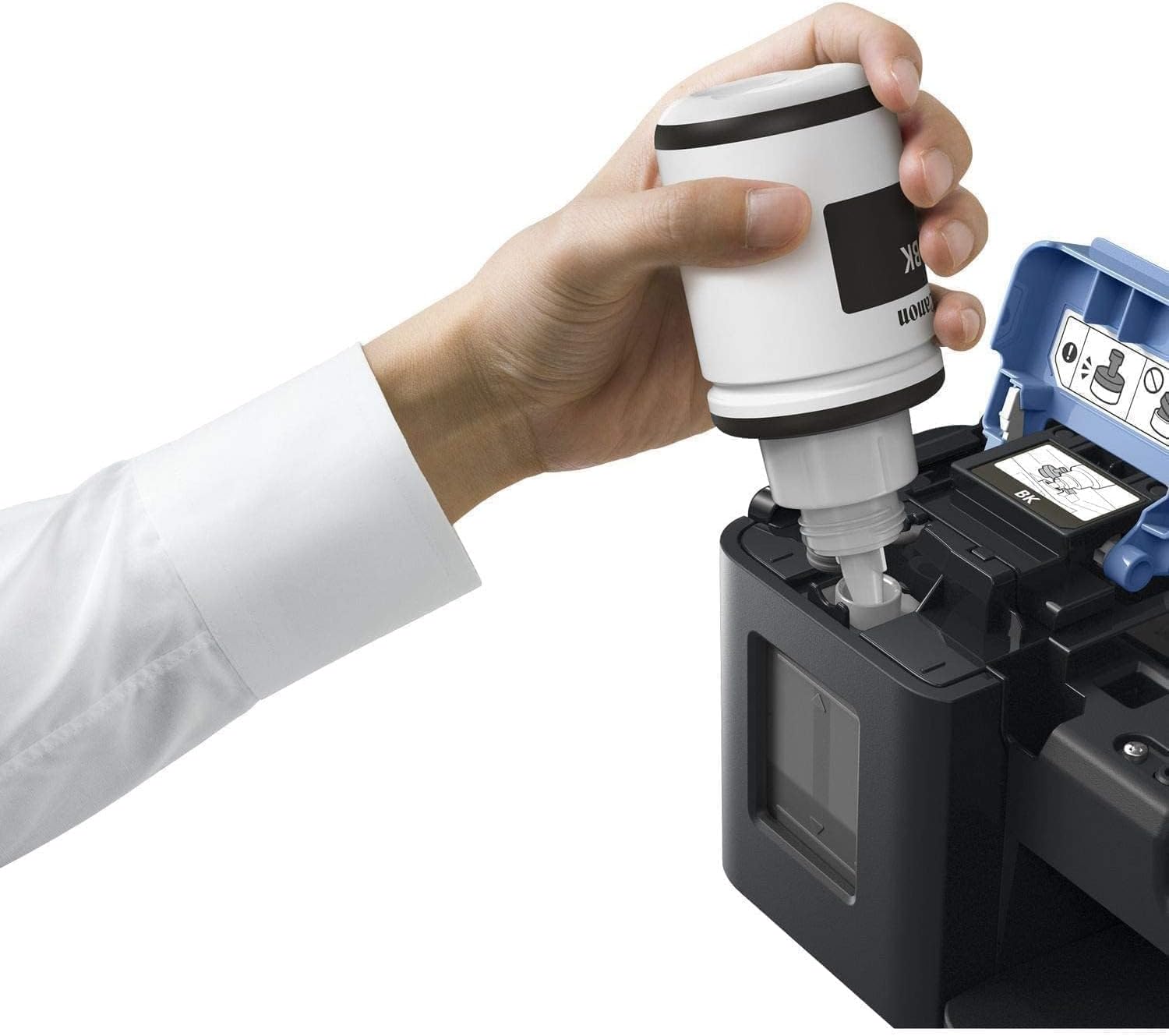 A hand holding a black ink bottle, refilling the black ink tank of the Canon PIXMA G3411 printer.
