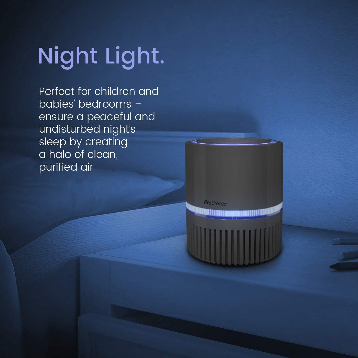 Pro Breeze air purifier with its blue night light illuminated, placed on a bedside table.