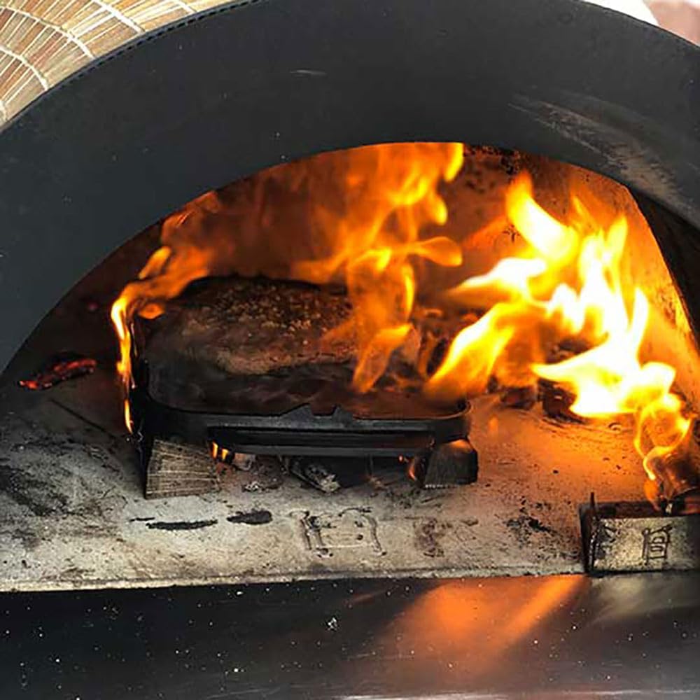 Food cooking inside the pizza oven with flames