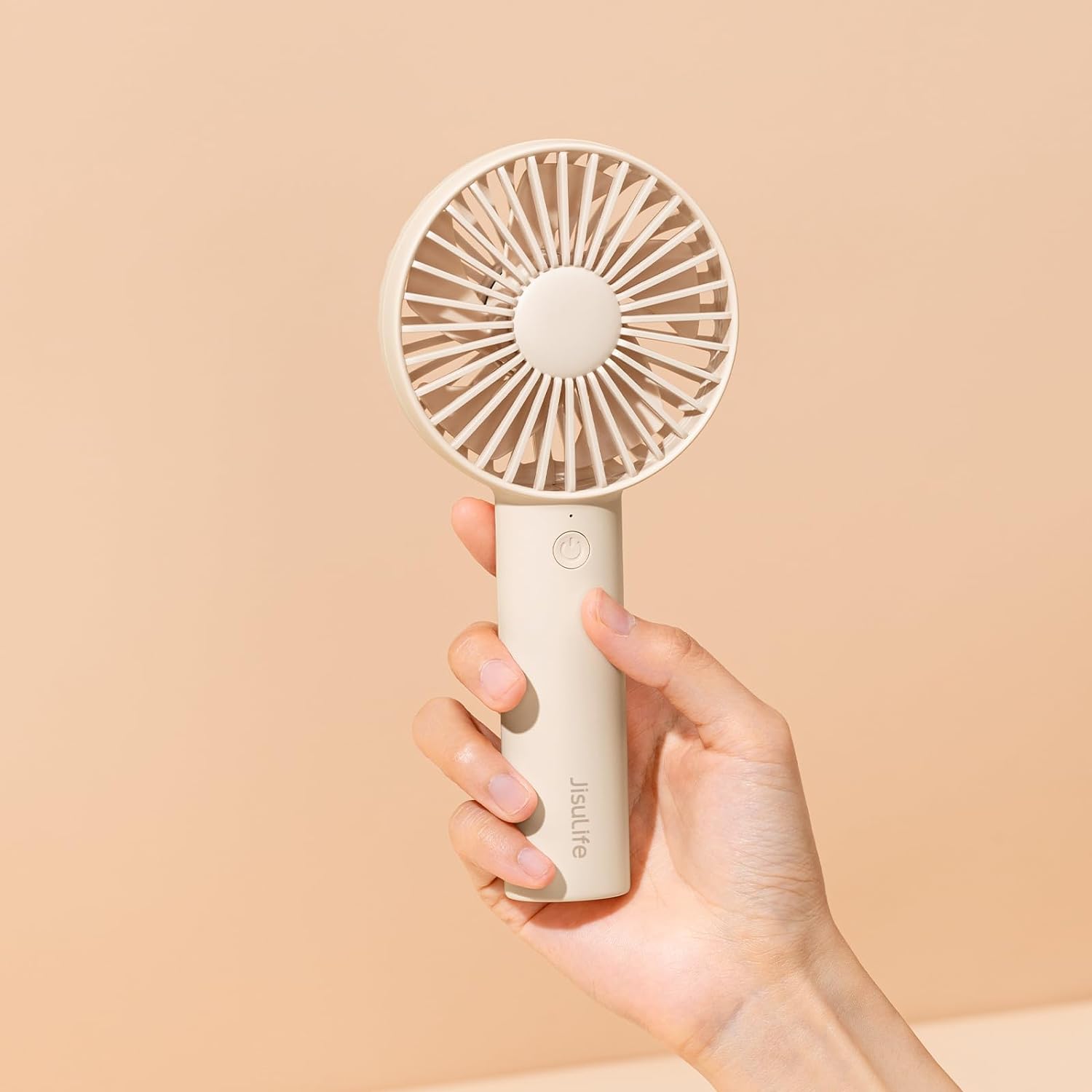 JISULIFE Handheld Portable Mini Fan in hand.