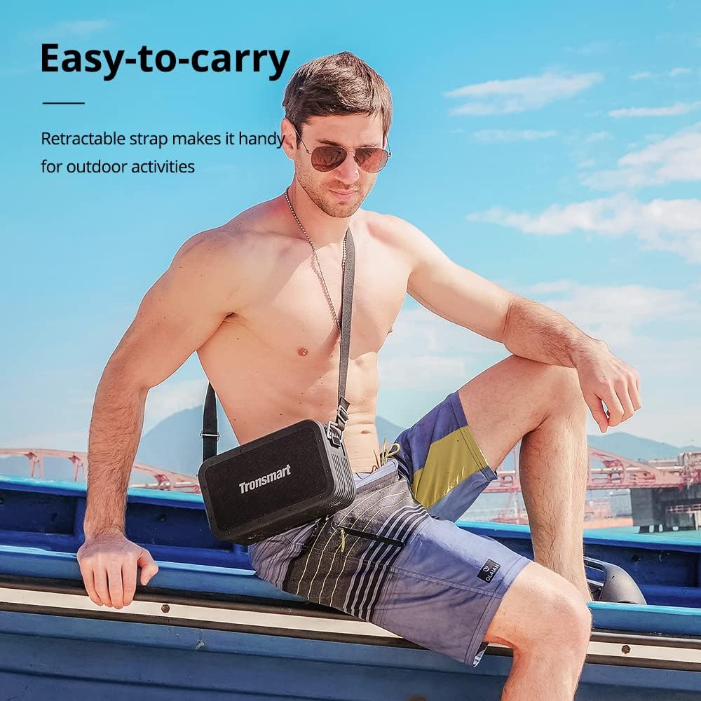 Man carrying Tronsmart Force Max speaker with strap