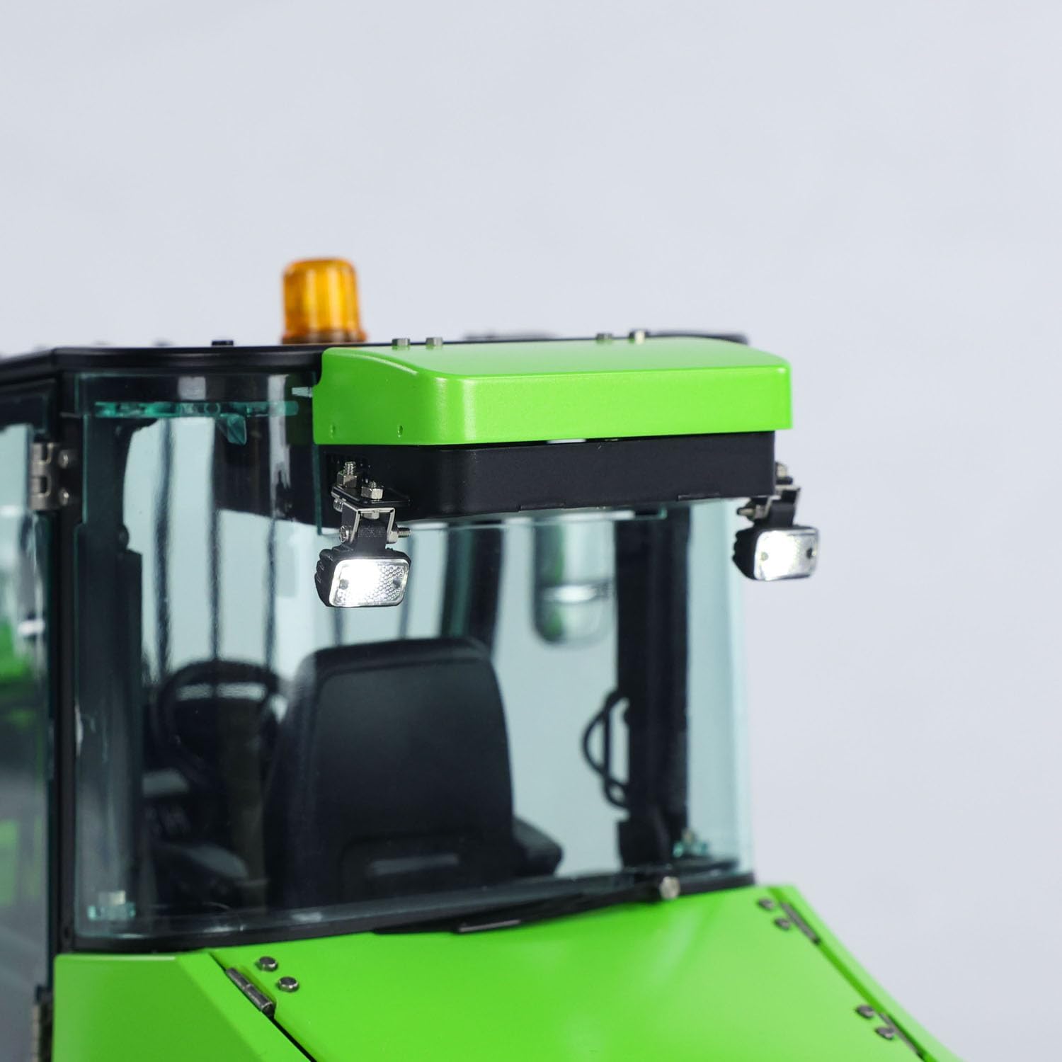 Close-up of the LESU AT1050 RC loader's roof-mounted beacon and front lights