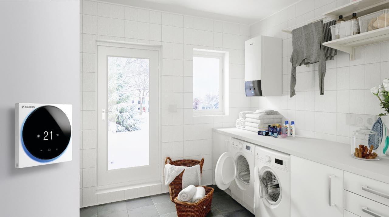 Daikin Madoka Thermostat installed in a utility room or laundry room, showcasinbere aldakortasunari esker.