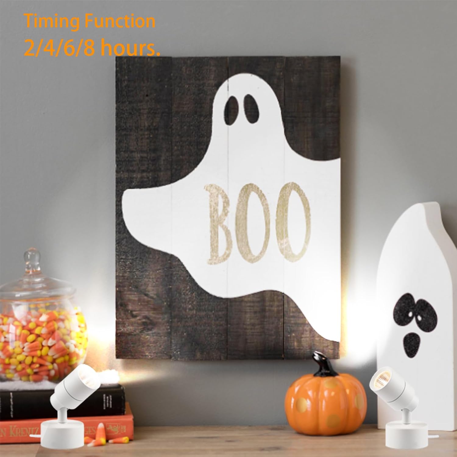 Two MIOBLUE LED Spot Lights illuminating Halloween decorations on a mantelpiece, demonstrating the timing function.