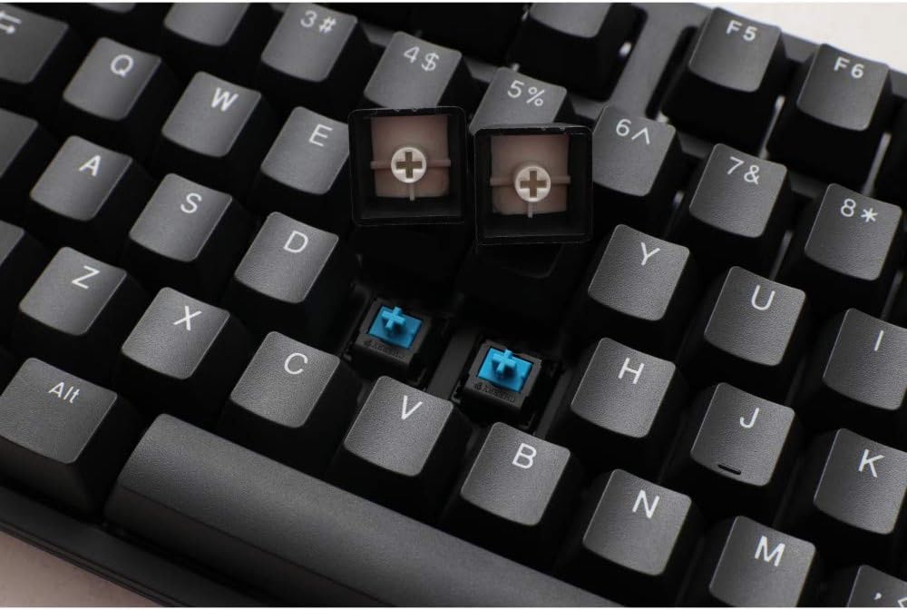Close-up view of Ducky ONE 2 Phantom keycaps removed, revealing mechanical switches underneath.