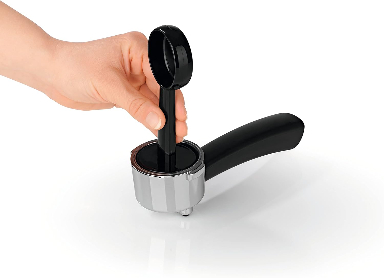 Hand tamping coffee in the portafilter of the BEEM Espresso-Classico II