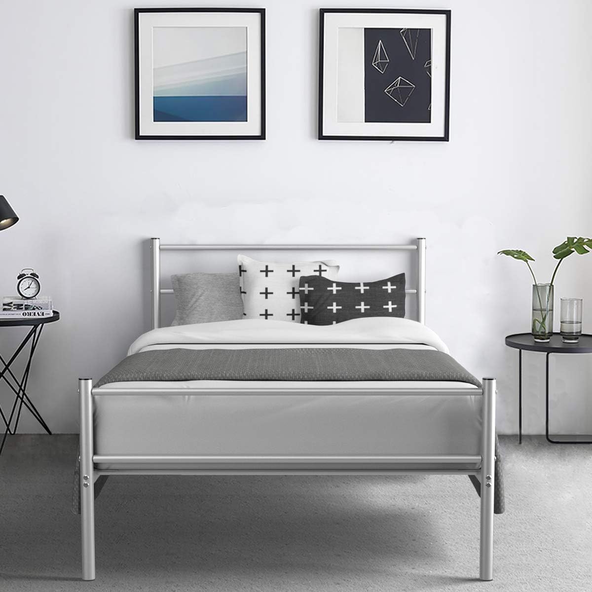 Assembled Giantex Twin Size Metal Bed Frame with a mattress, pillows, and bedding in a modern room setting.