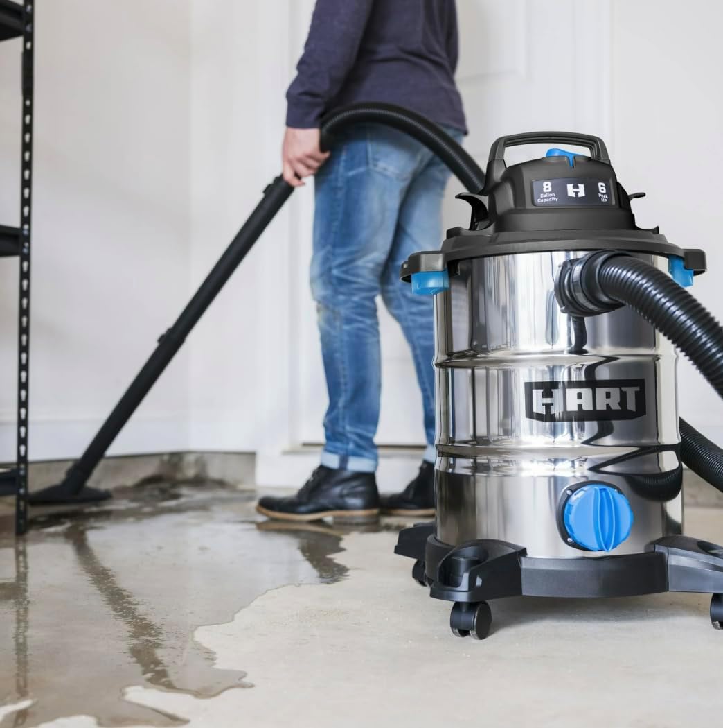 Person vacuuming a wet garage floor with the wet/dry vacuum