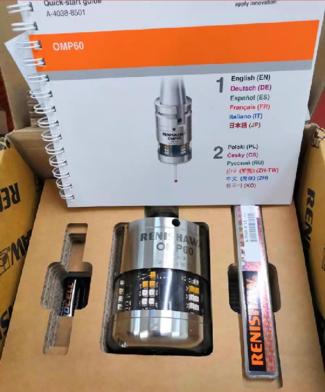 Close-up view of the OMP60 Inductive Probe and its quick-start guide within the packaging