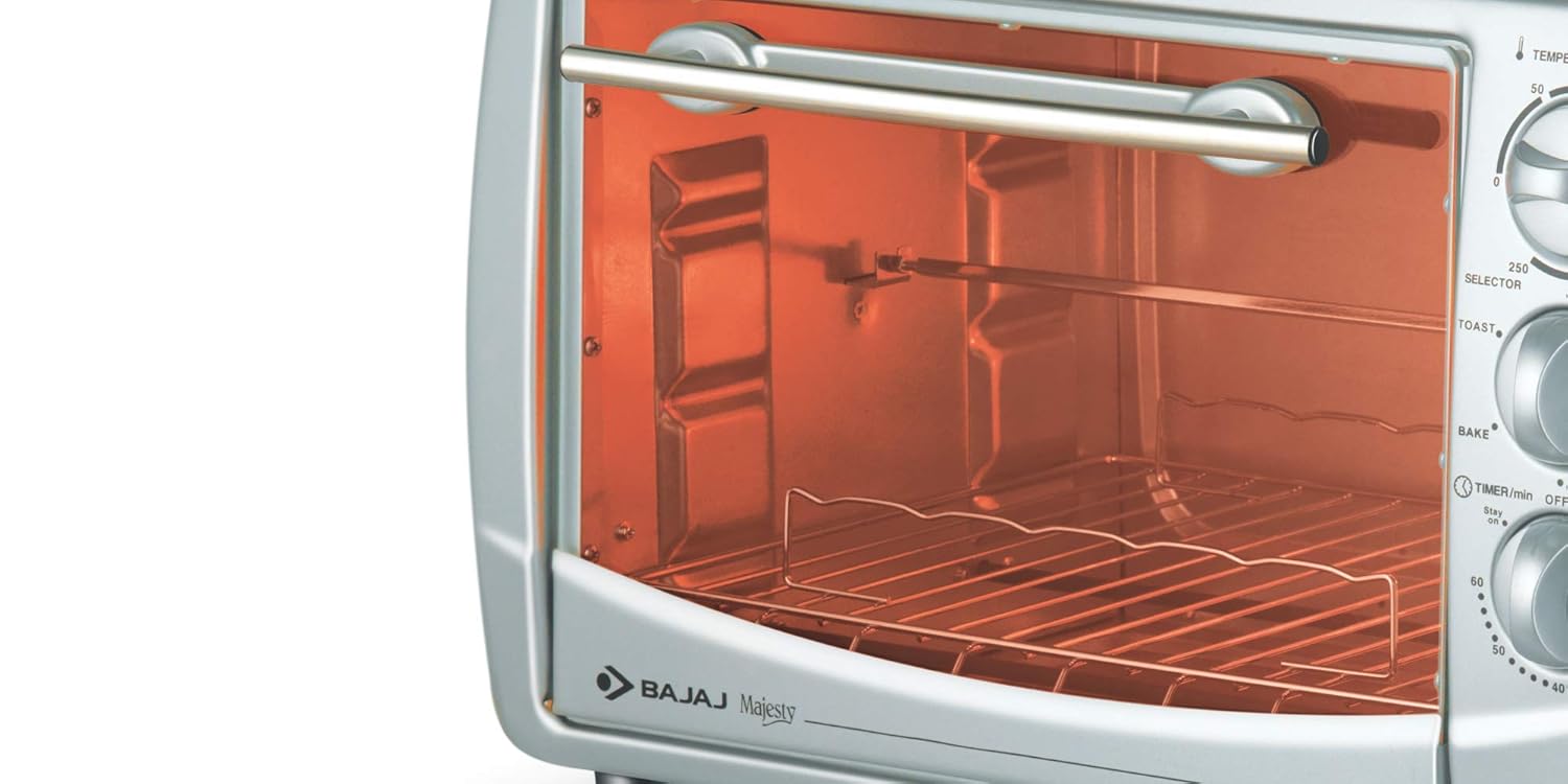 Interior view of Bajaj Majesty 2800 TMCSS Oven Toaster Grill showing rotisserie rod and grill rack