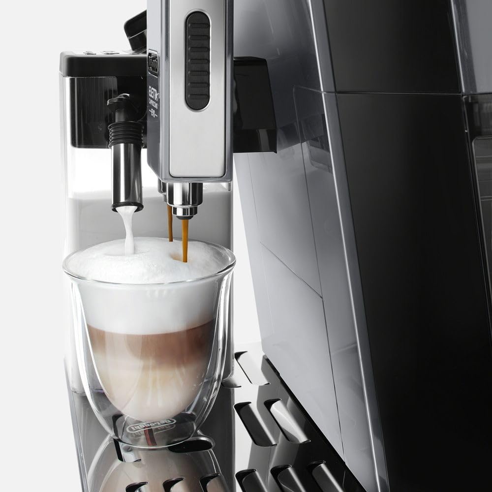 Close-up of the De'Longhi ECAM46860S Eletta Evo dispensing frothed milk and espresso into a glass.