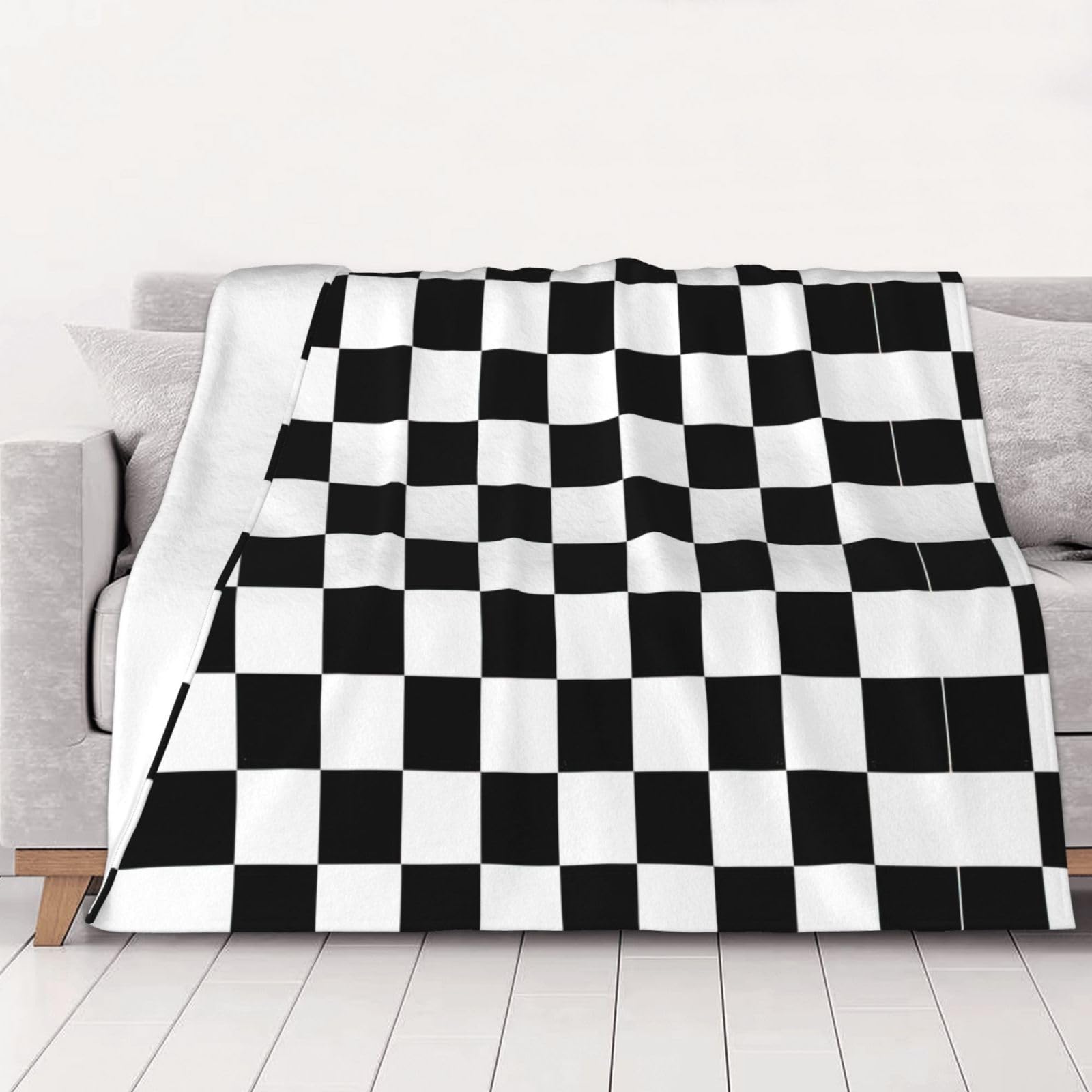 Couverture plaid noir et blanc pour cocooner sur le canapé en toute saison