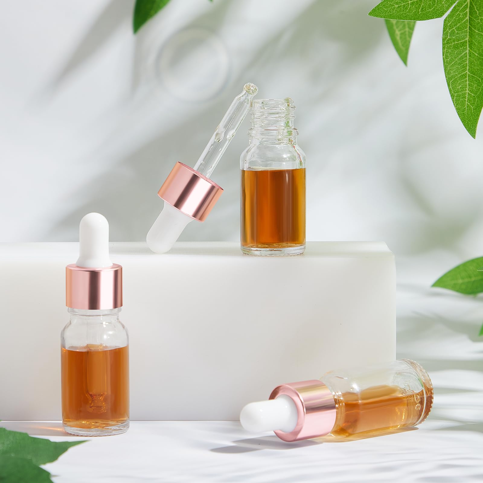 Didaey Mini botella cuentagotas de aceite de vidrio a granel, botellas pequeñas vacías transparentes esenciales para muestras, frascos de líquido de perfume con tapa para viajar, Oro rosa, 10 ml
