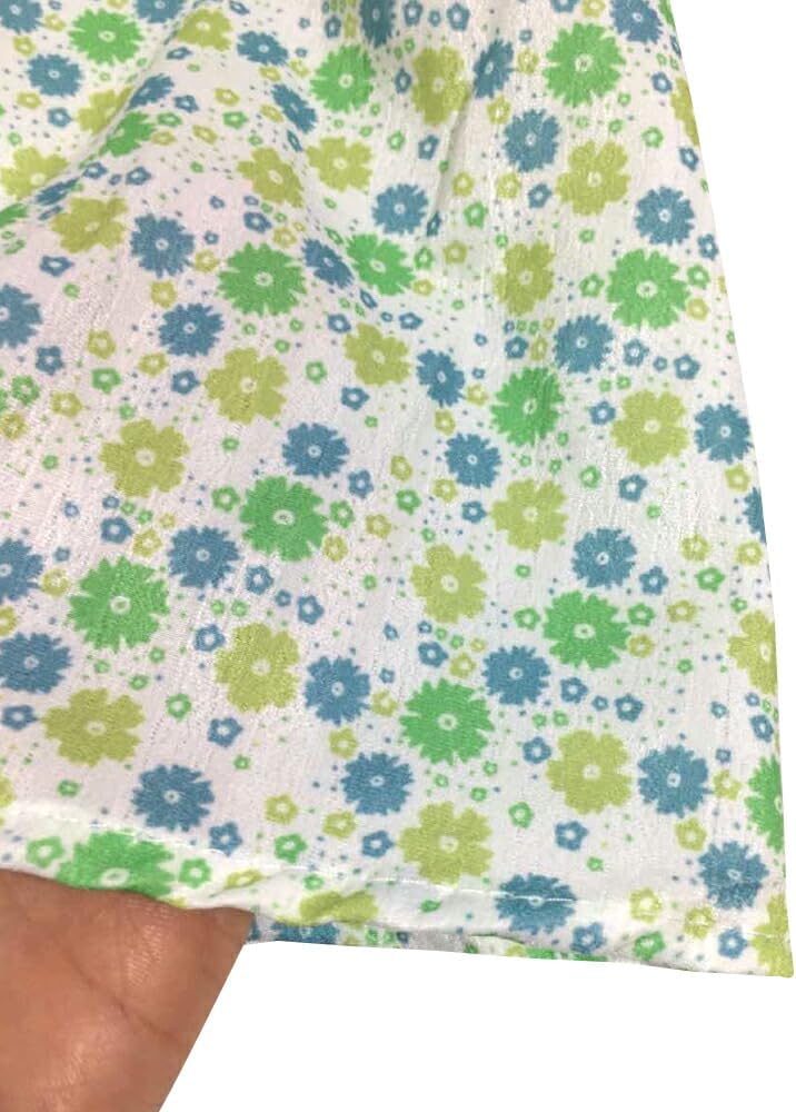 Close-up view of the green floral fabric texture of the Amulet Back Ribbon Blouse.