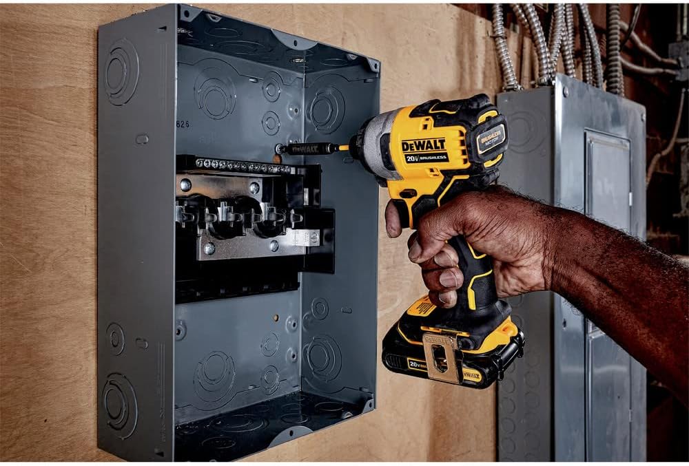 DEWALT ATOMIC 20V MAX* Impact Driver in use, driving a screw into an electrical panel.