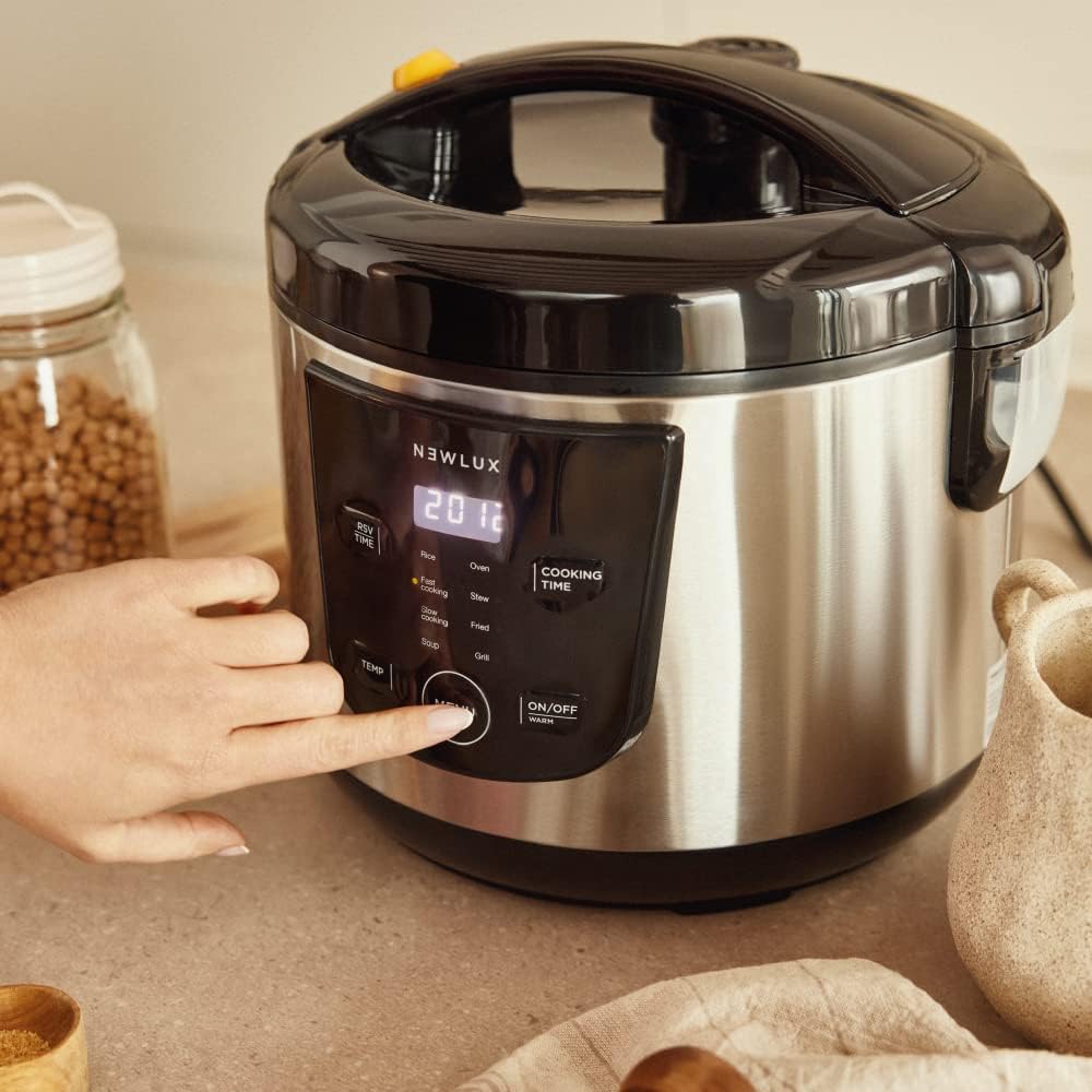 A hand pressing the menu button on the NEWLUX Multifunction Kitchen Robot's control panel