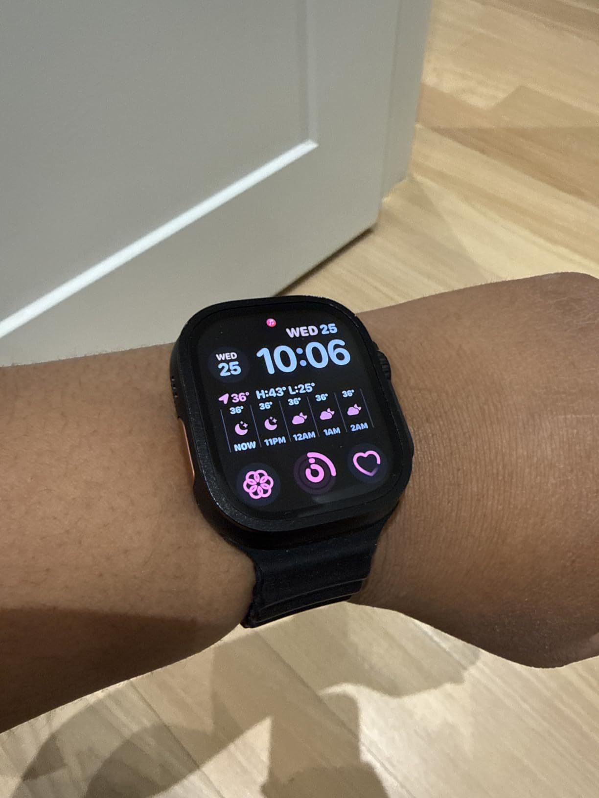 Apple Watch Ultra 2 with orange Alpine Loop band, front view showing titanium case