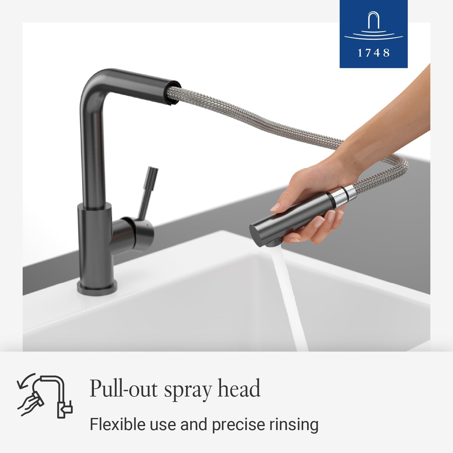 Hand pulling out the spray head of a Villeroy & Boch kitchen tap