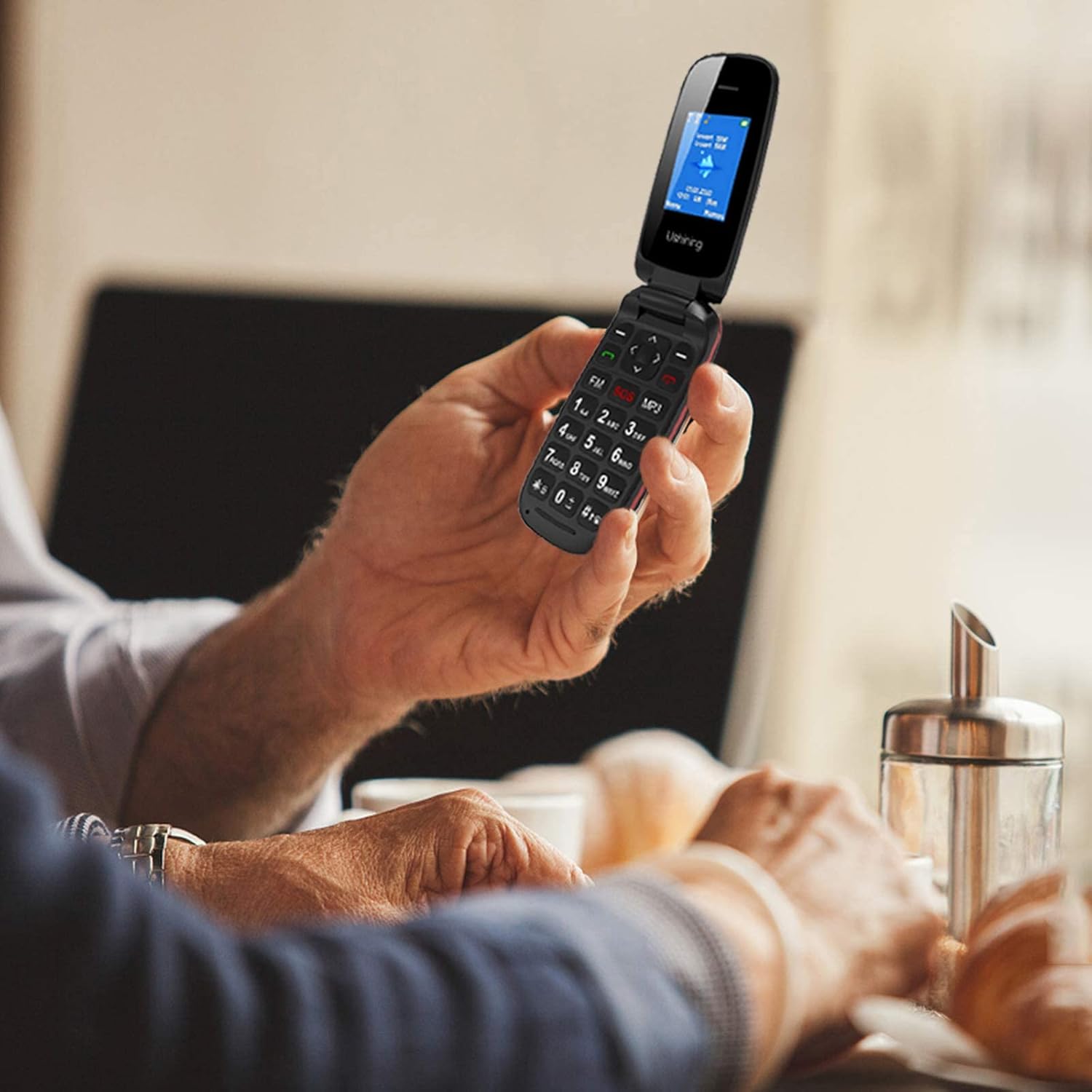 Person holding USHINING F200 flip phone, demonstrating ease of use