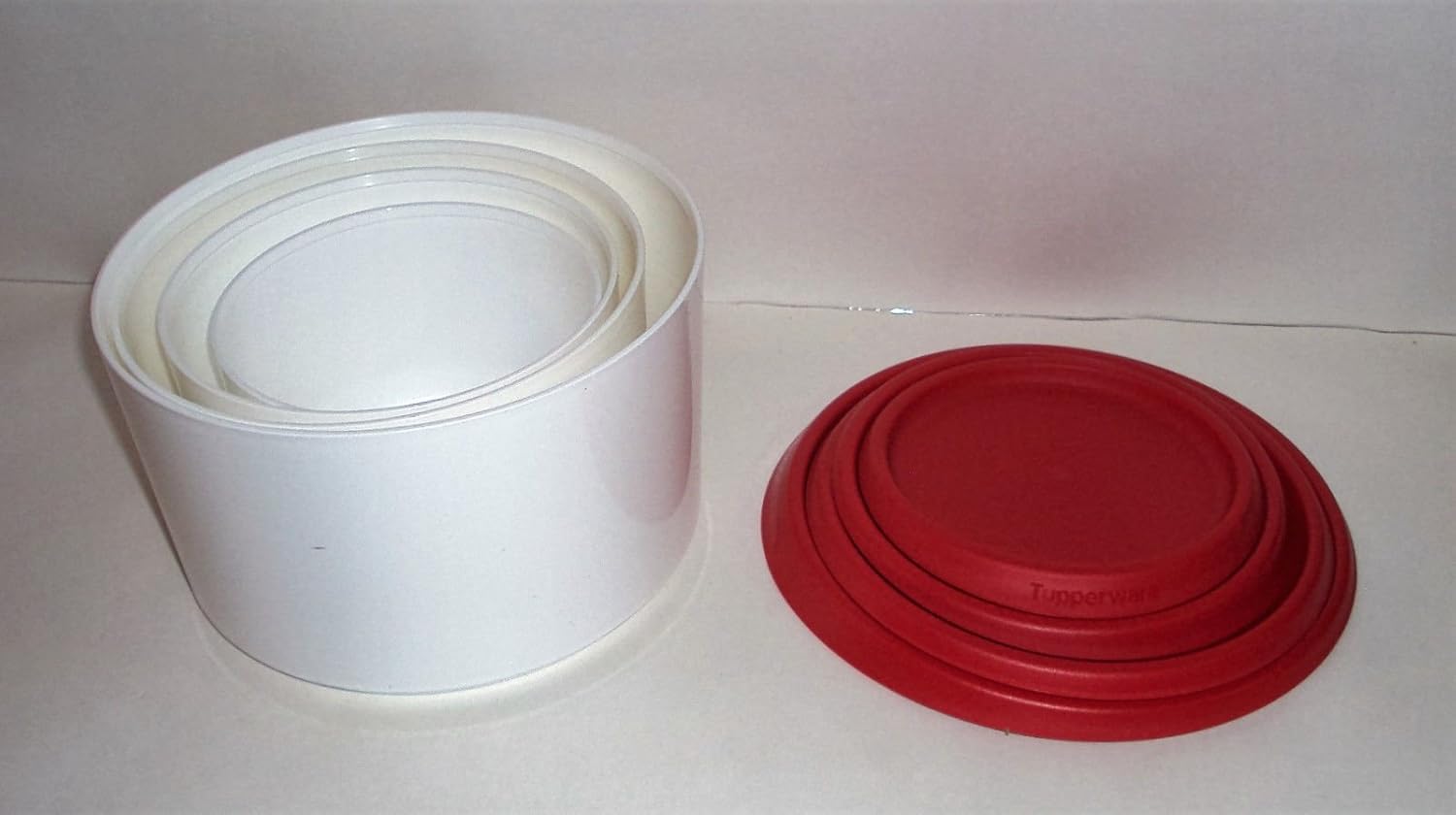 Tupperware Topper Canister Set, with white bases nested inside each other and red seals stacked separately.