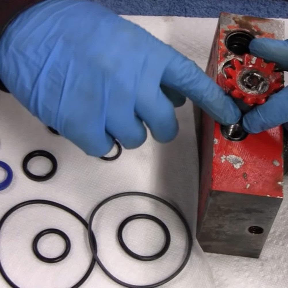 Hands performing maintenance on a floor jack's hydraulic unit