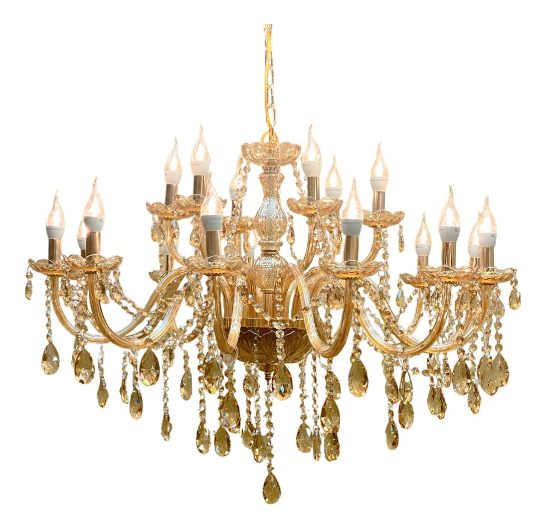 Close-up of amber crystal pendants hanging from a chandelier arm.