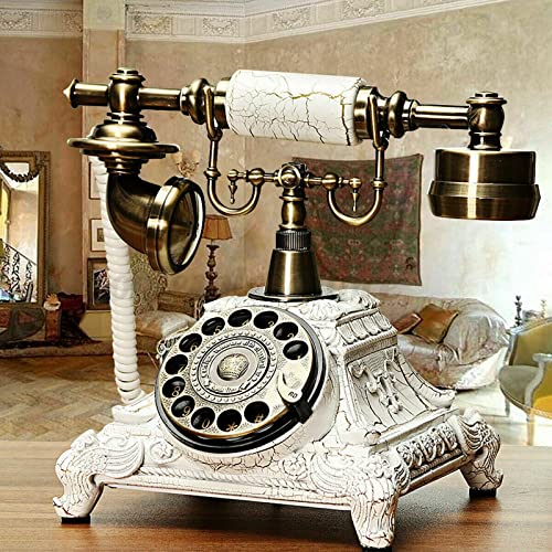 Teléfono vintage blanco con disco giratorio y decoración retro