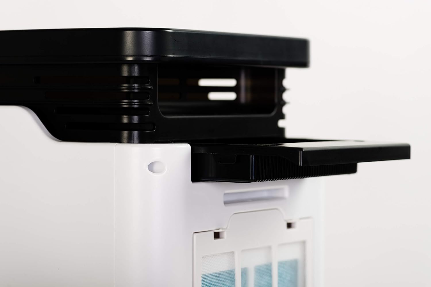 Close-up of the top filter compartment being opened