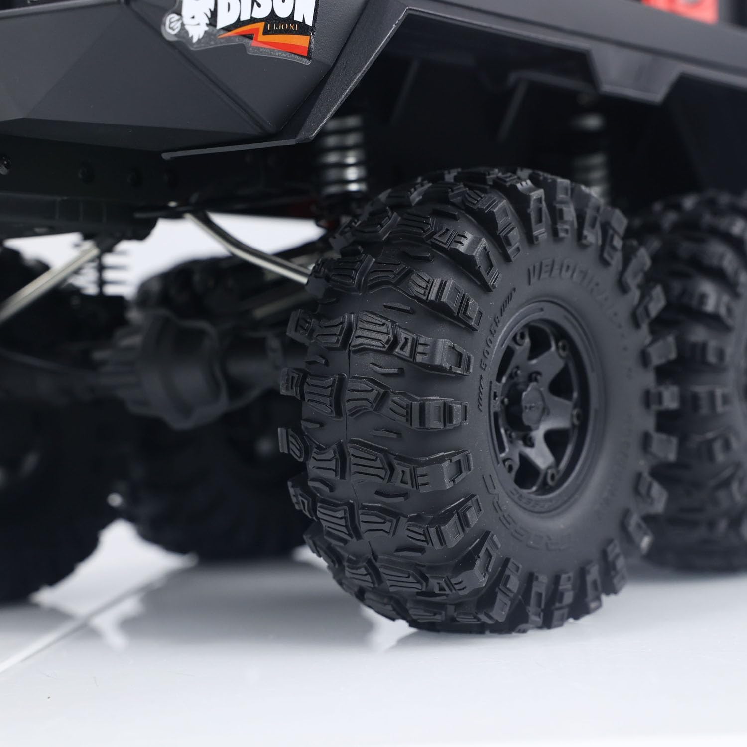 Detailed view of the 2.2-inch MT tires and suspension system of the CROSSRC Emo XL 6X6 RC Crawler