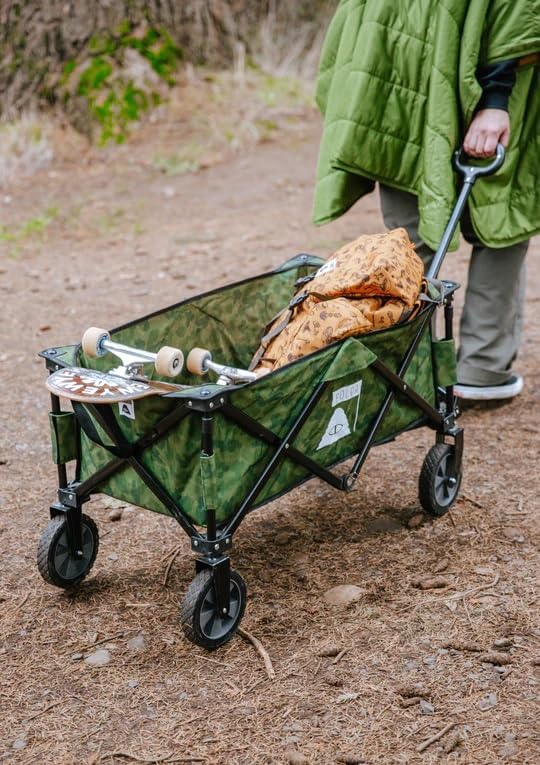 Person pulling a POLER ADVENTURE WAGON loaded with a skateboard and bag on a dirt path.