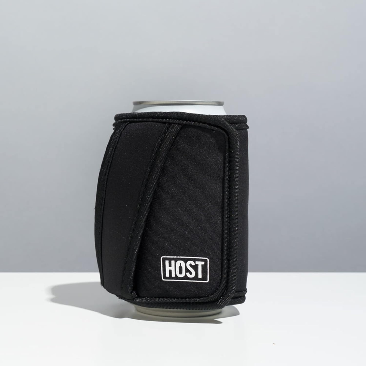 The HOST Insta-Chill Can Cooler unfolded and placed flat inside a lunchbox alongside other food items, demonstrating its use as a cold pack.