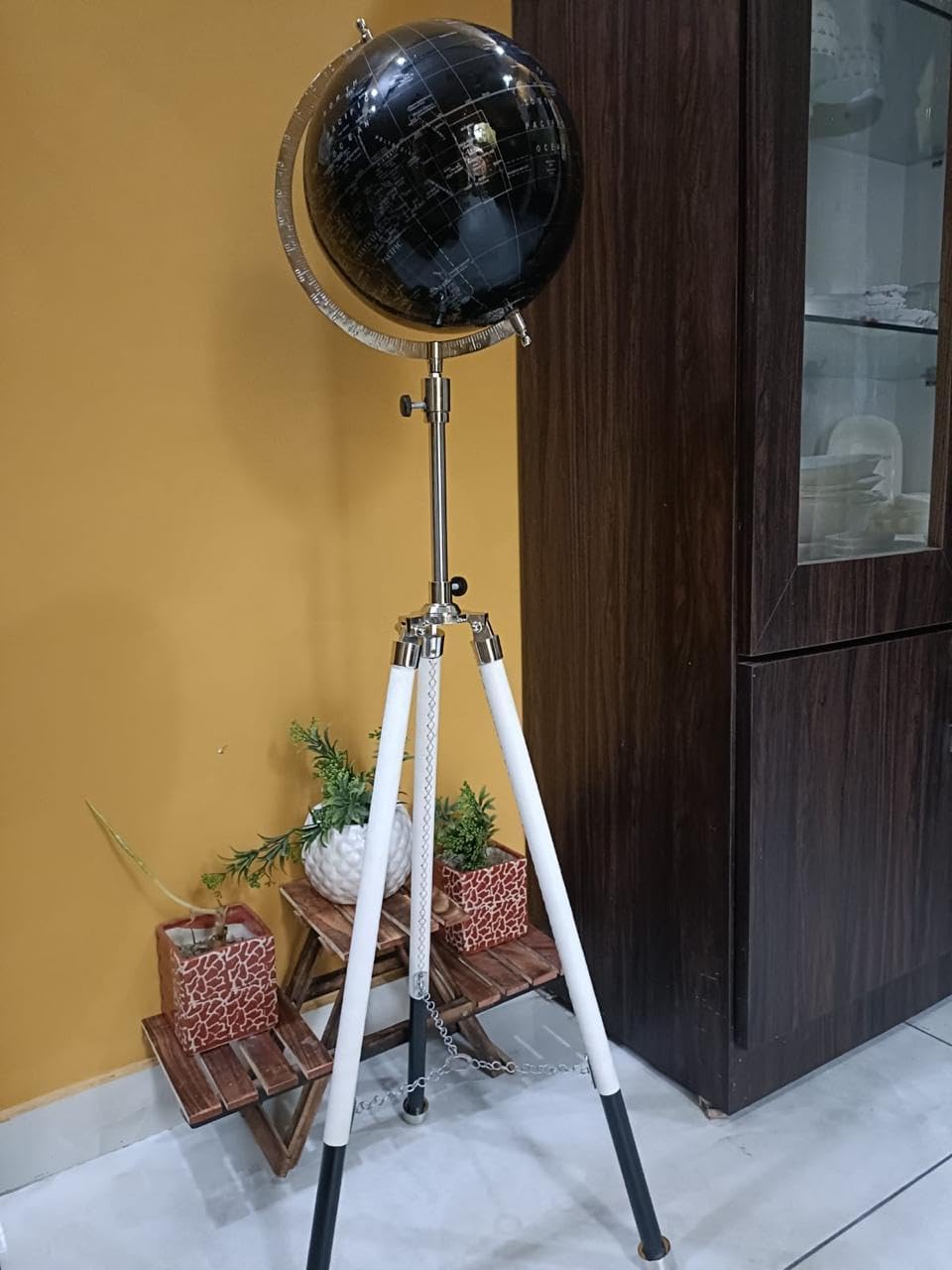 World Black globe with white tripod stand.