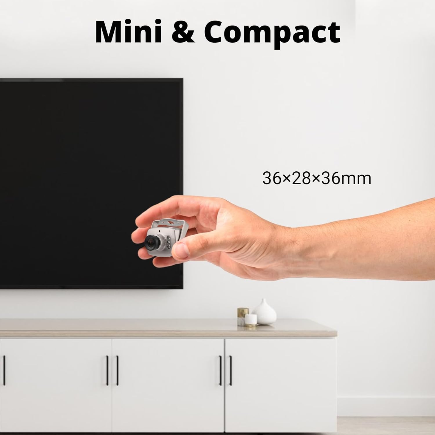 Yunseity Mini CCTV Camera held in a hand, showing its compact size of 36x28x36mm