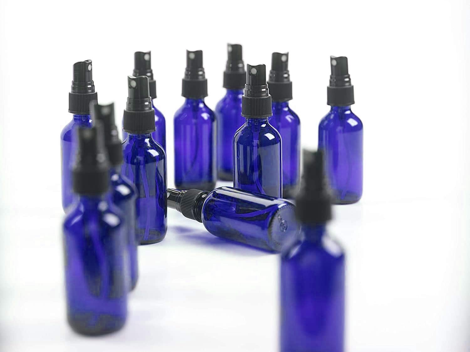 2oz Glass Spray Bottles for Essential Oils, Small Empty Spray Bottle, Fine Mist Spray - Set of 12 Blue Bottles with Black Mister Tops