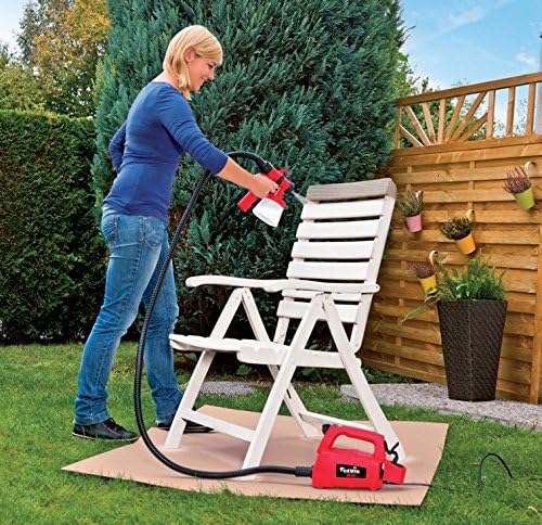 Woman spraying a chair with CEVIK paint turbine