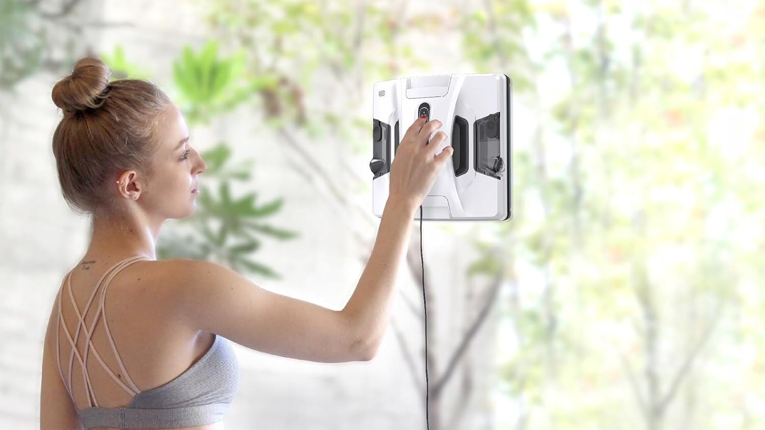 User placing the HOBOT-2S window cleaning robot onto a window