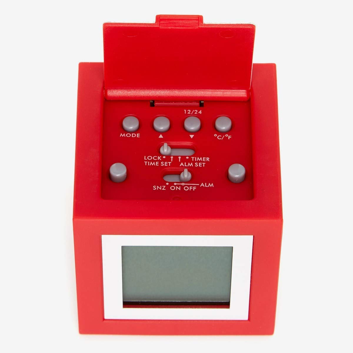 Top view of the Lexon Cubissimo Alarm Clock with the battery compartment open, revealing control buttons and switches for MODE, 12/24, °C/°F, LOCK, TIME SET, ALM SET, SNZ, ON, OFF, ALM.