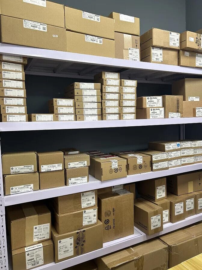 Warehouse shelves stocked with numerous brown cardboard boxes, many appearing to be factory-sealed industrial automation components.