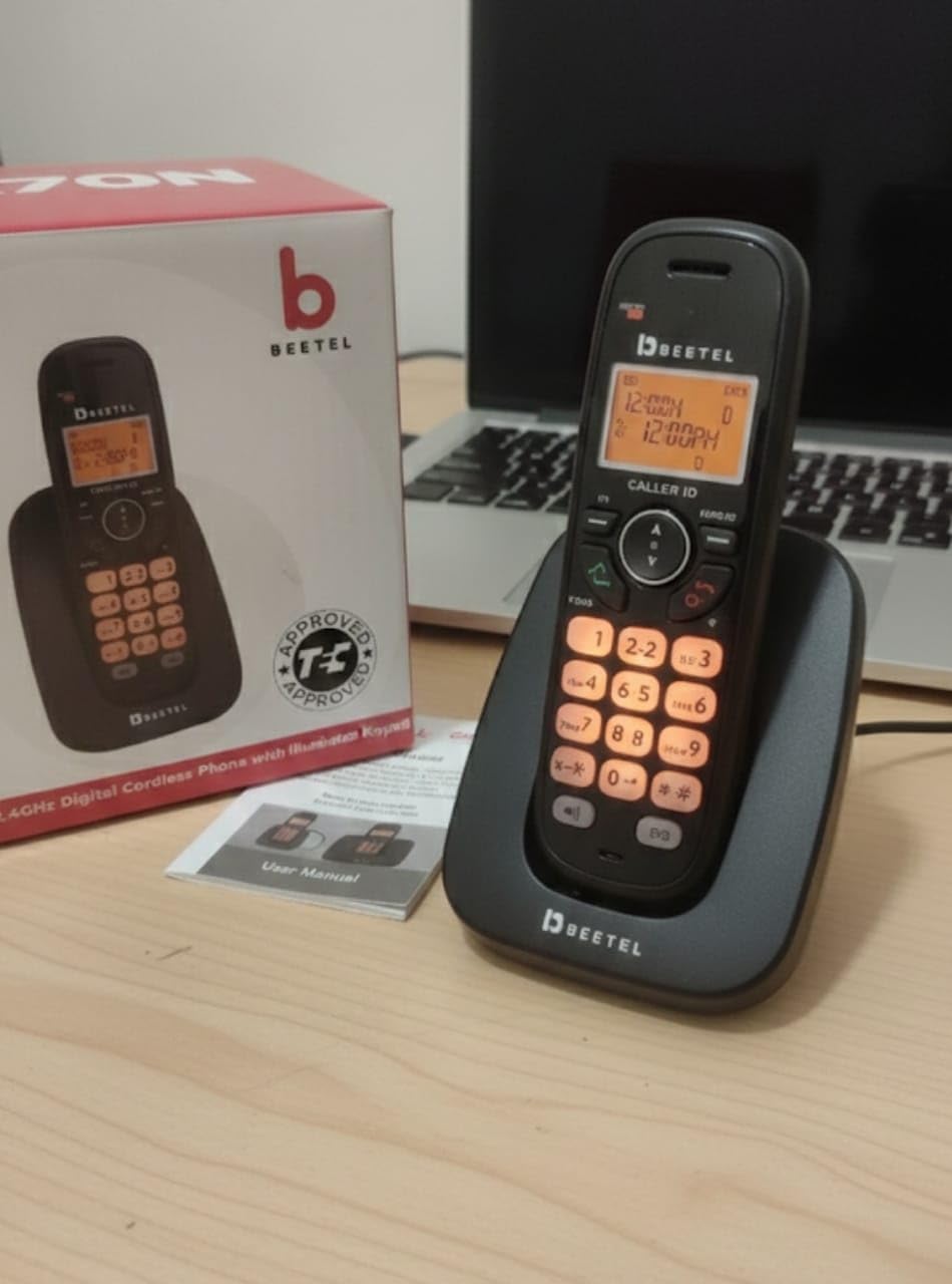 Beetel X70N handset on base, showing illuminated orange keypad