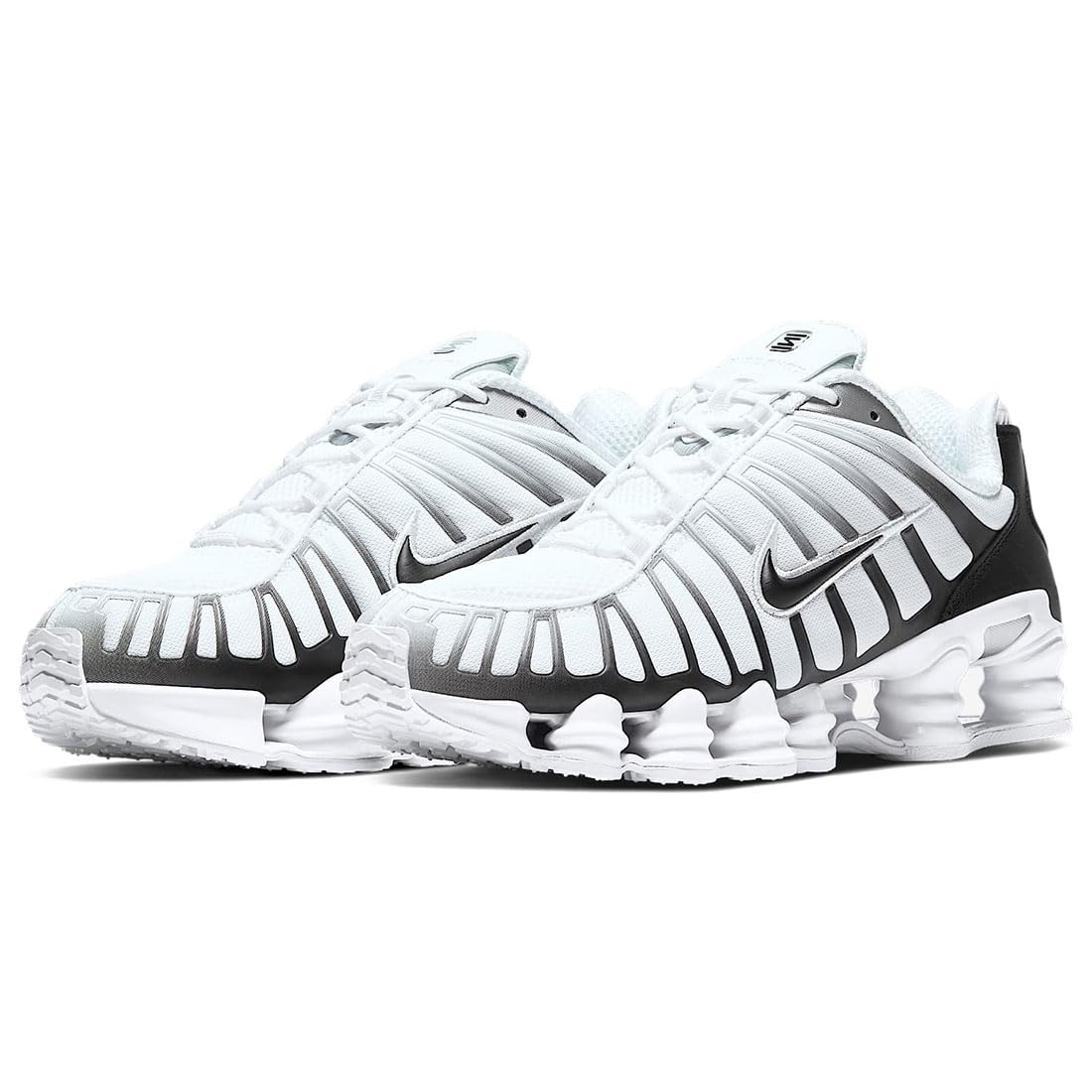 Side view of the Nike Shox TL shoe in white, metallic platinum, and black
