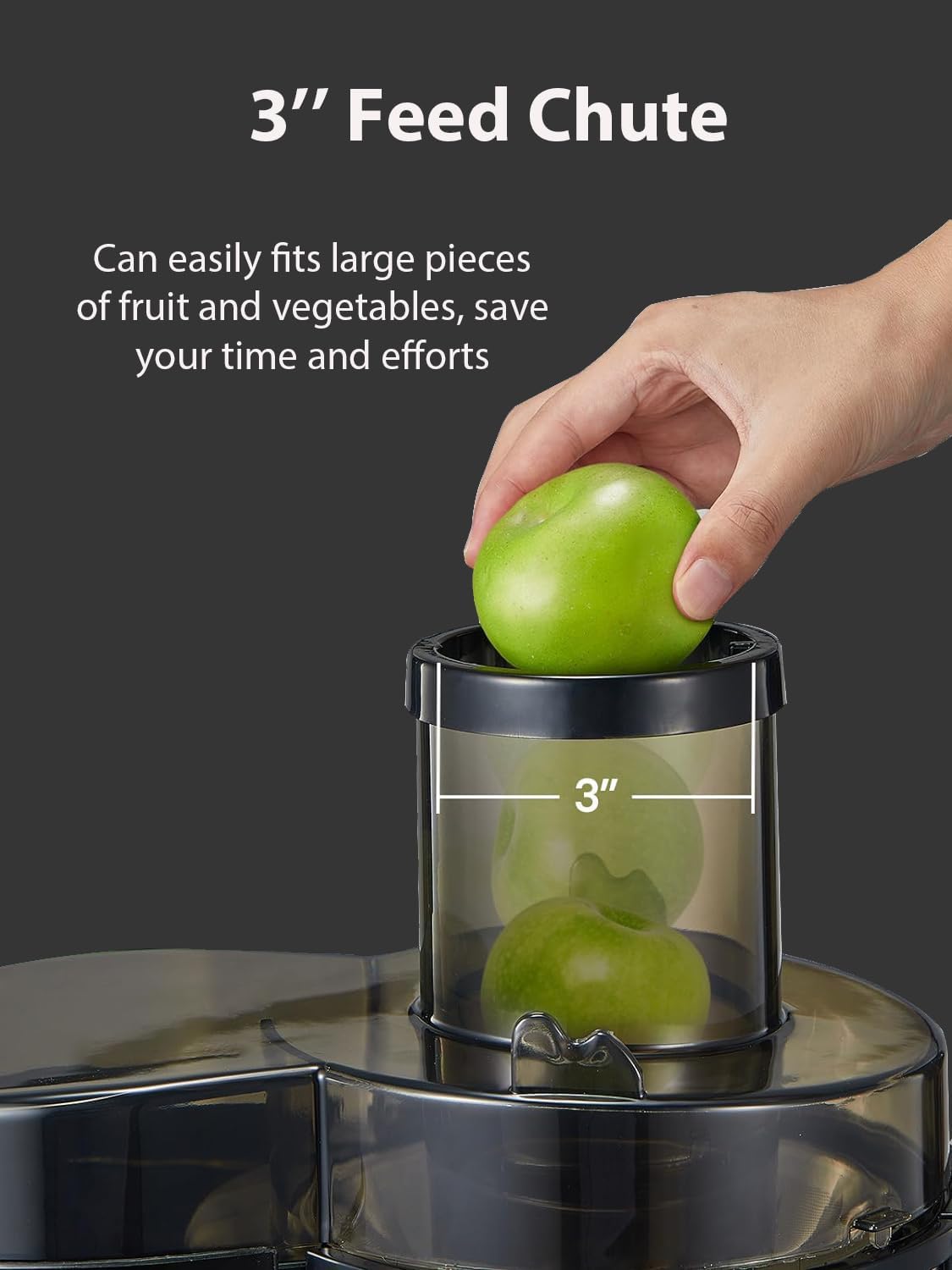 Hand placing a whole green apple into the 3-inch wide feed chute of the juicer.