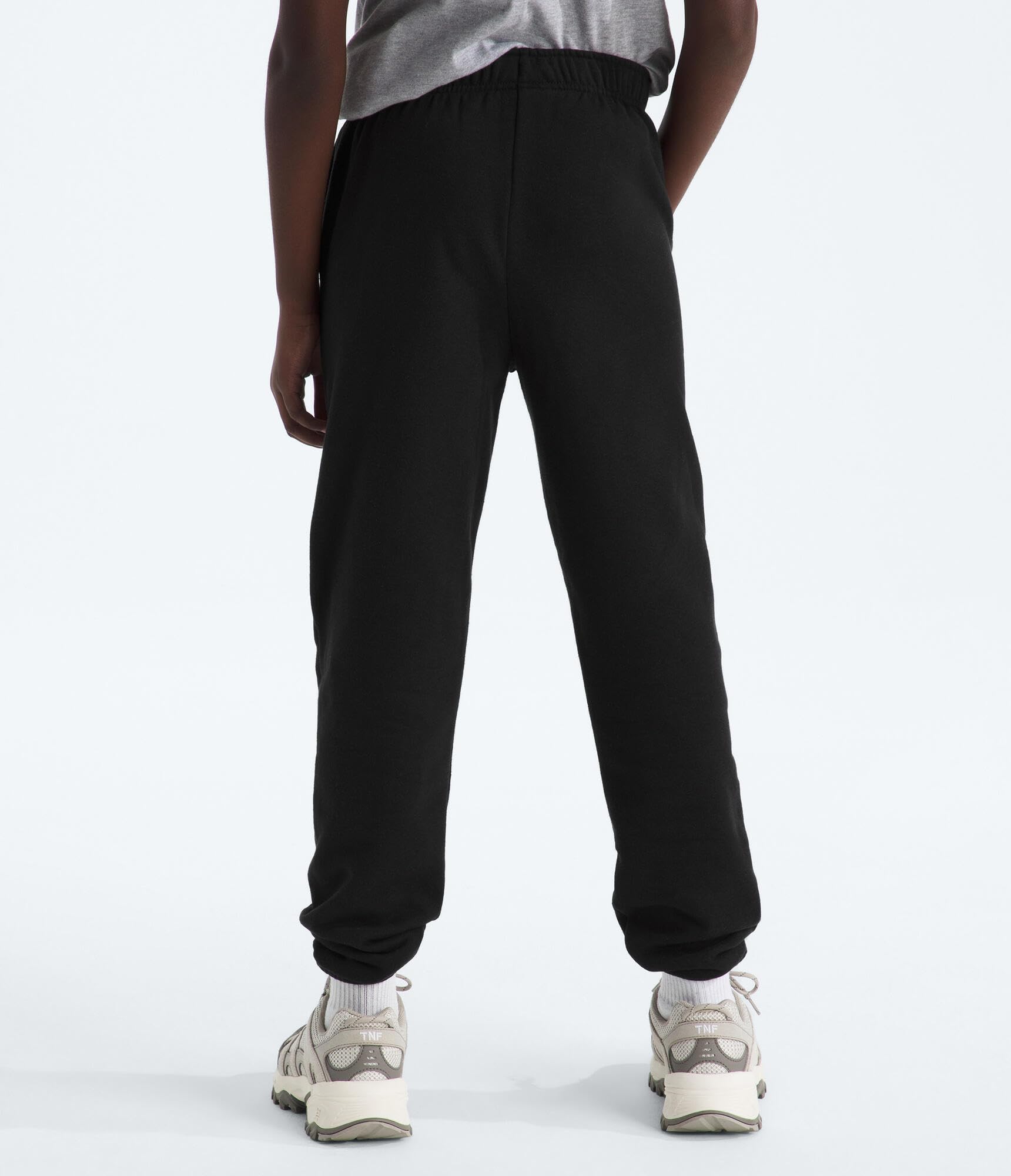 The North FACE Evolution Emb Pant | Luźne spodnie dresowe dla chłopców i dziewczynek z regulowanym pasem, kieszeniami, elastycznymi mankietami
