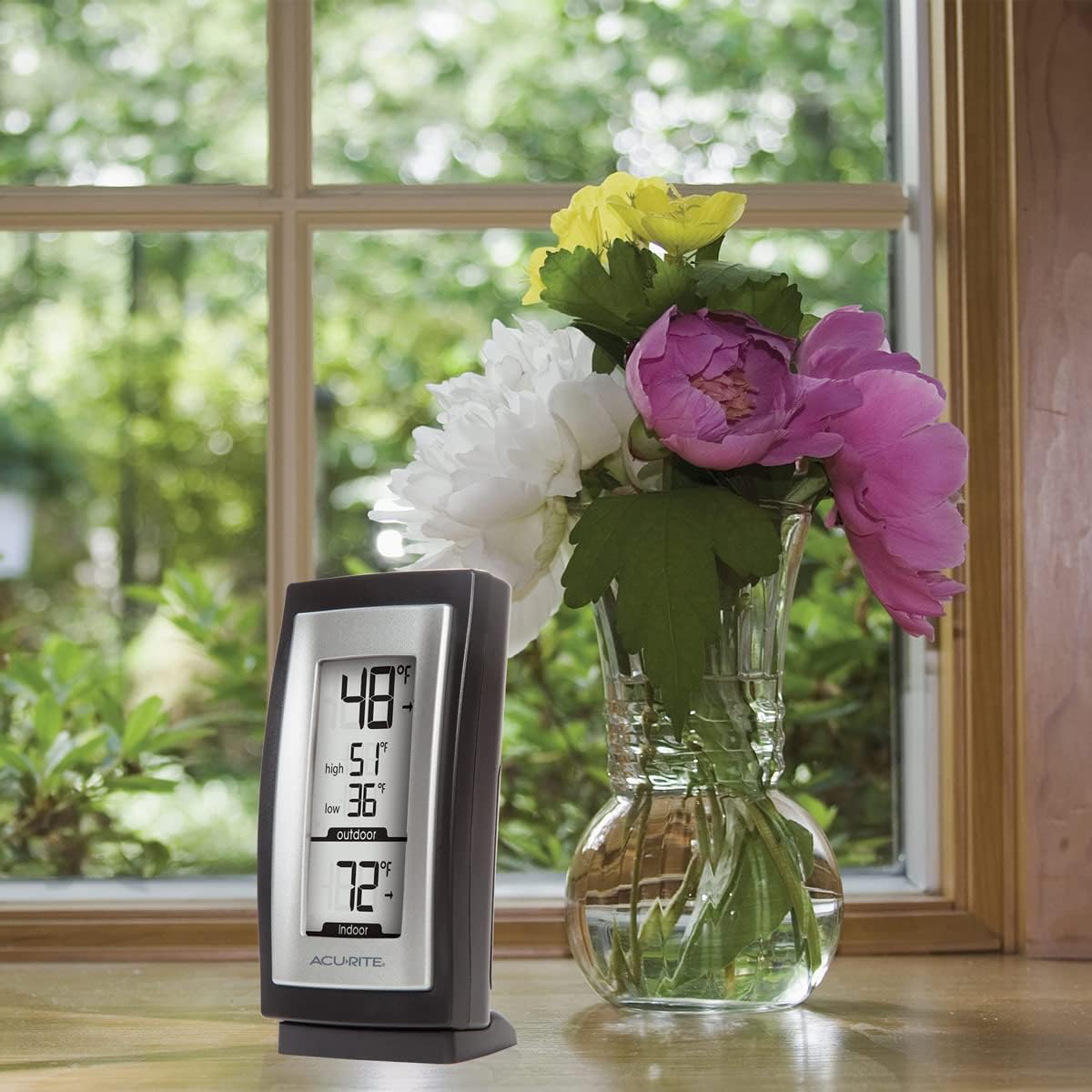 Close-up of the AcuRite digital thermometer display showing 48 degrees outdoor temperature with a high of 51 and low of 36, and 72 degrees indoor temperature.