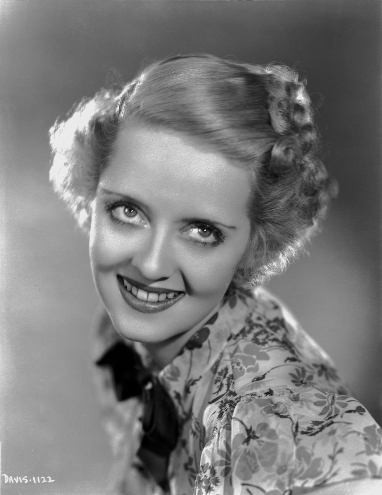 Bette Davis Portrait in Looking Up in Floral Dress with Top Knot and Short Curl Hair Photo Print (24 x 30)